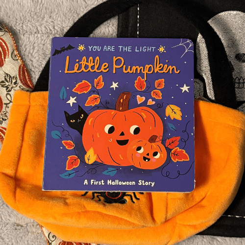 Illustrated cover of Little Pumpkin board book showing forest animals gathered around a glowing pumpkin at night